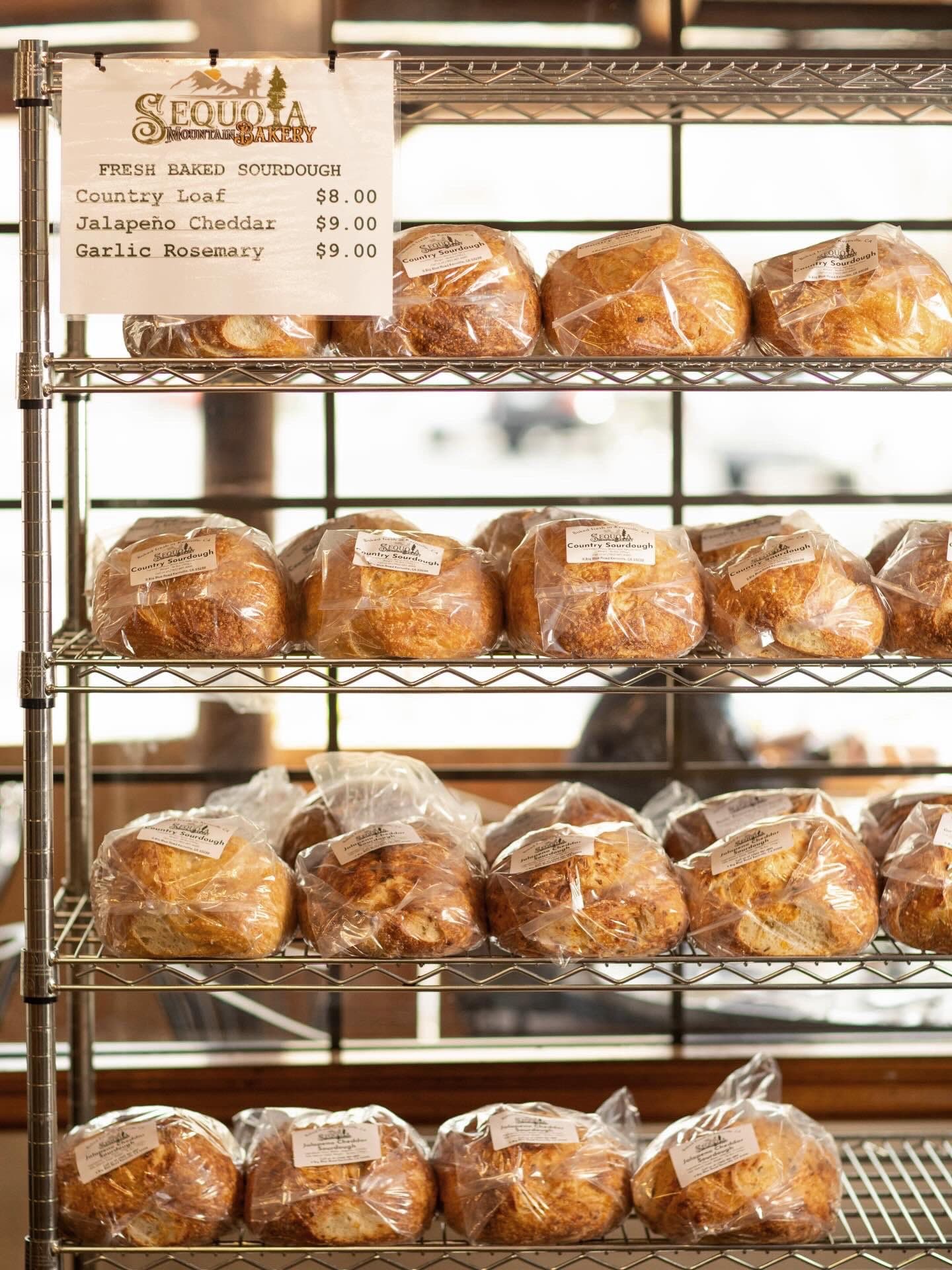 Fresh-baked sourdough loaves on the bakery shelf